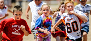 Kids running and playing in a group activity setting.